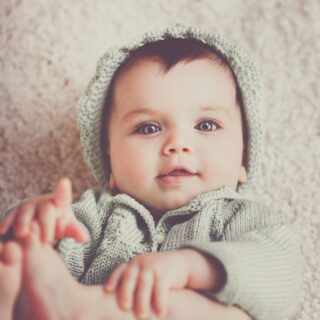 Baby lying on the floor at home