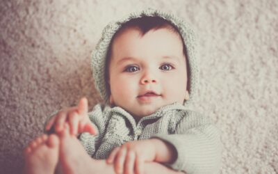 Baby lying on the floor at home